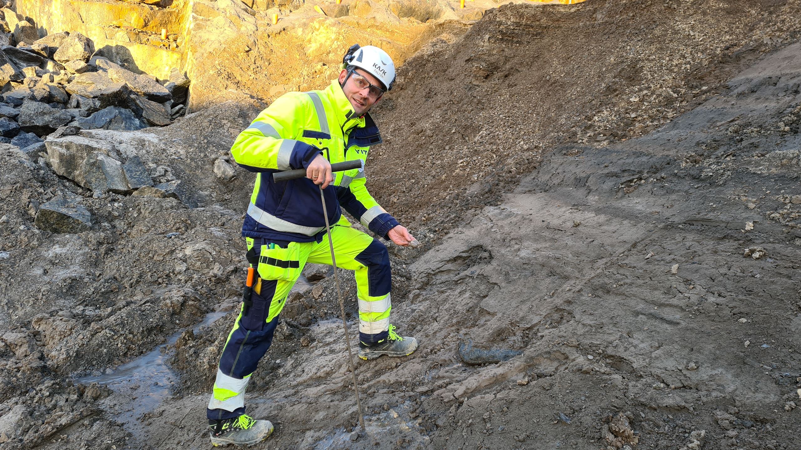 Man i byggnadsklöder på en arbetsplats